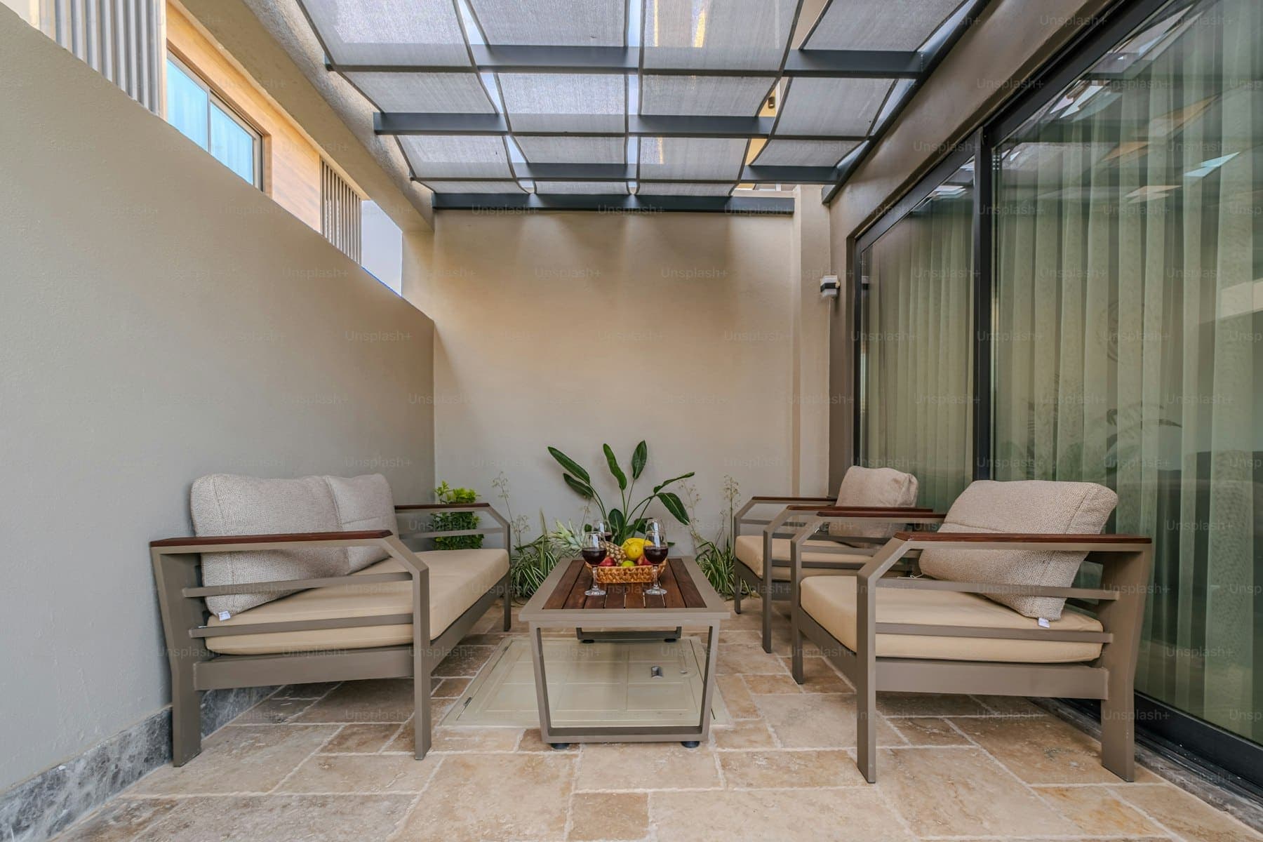 Outdoor patio with a wooden pergola and lounge seating