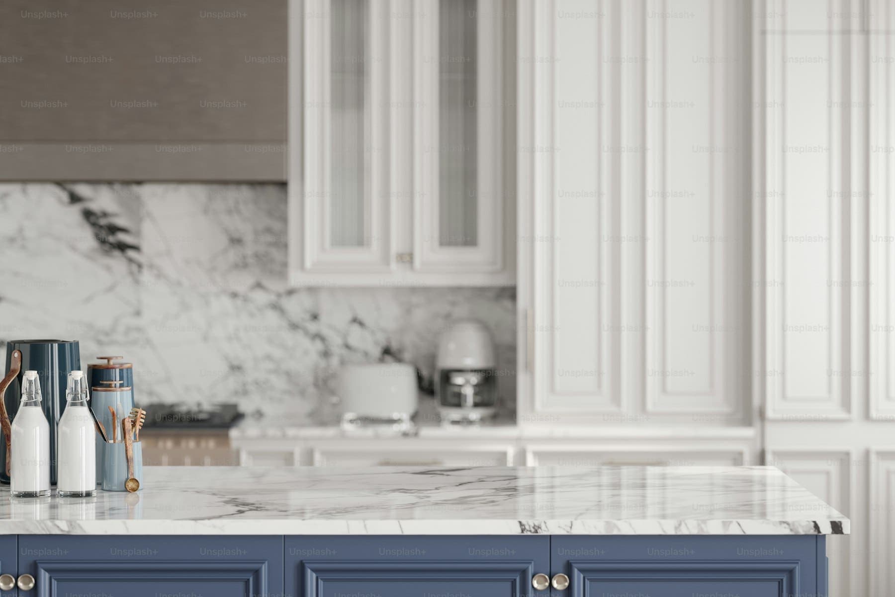 Kitchen island with a stone waterfall edge and pendant lighting