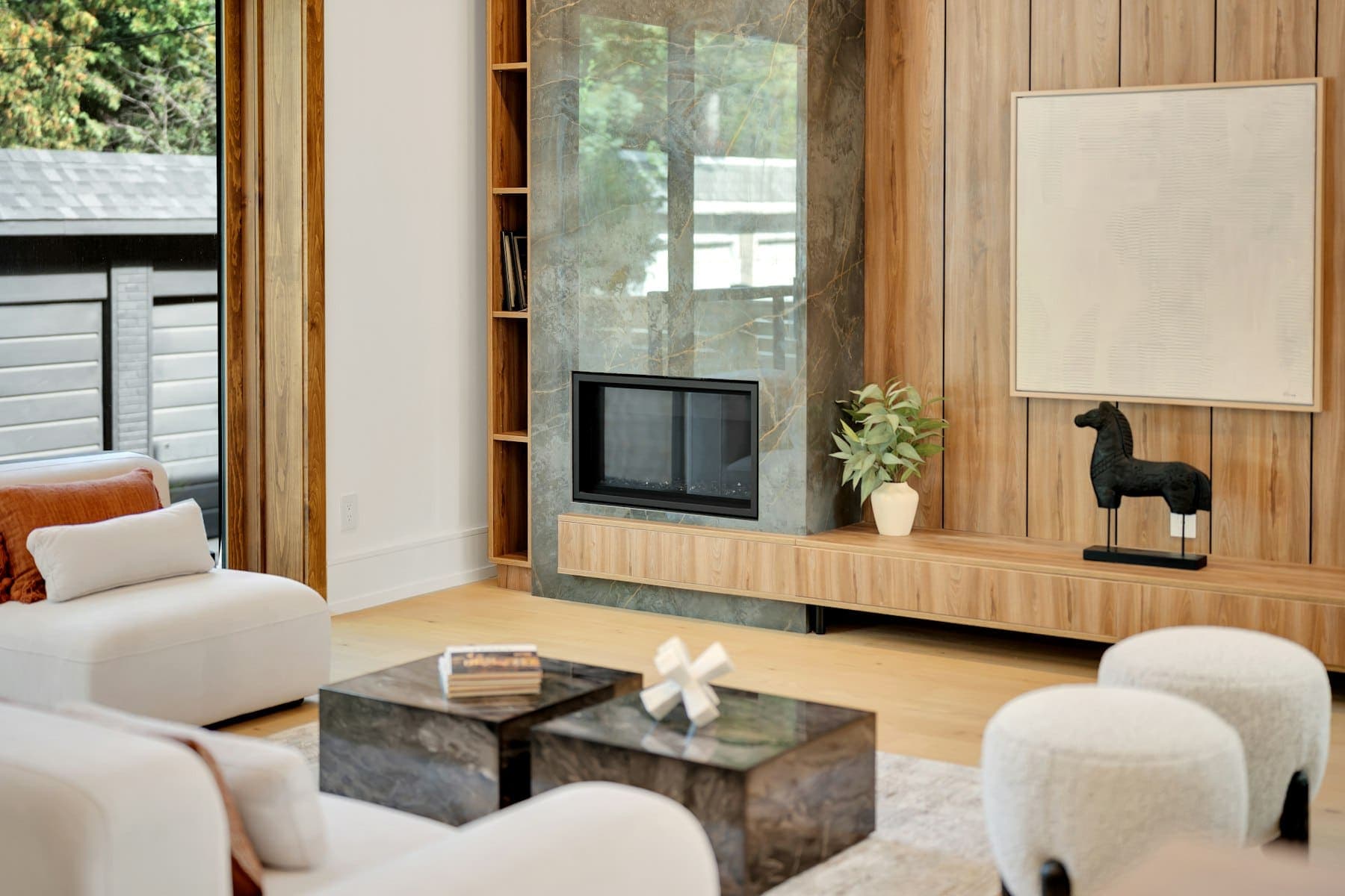 Living room with a linear fireplace and custom built-in shelving